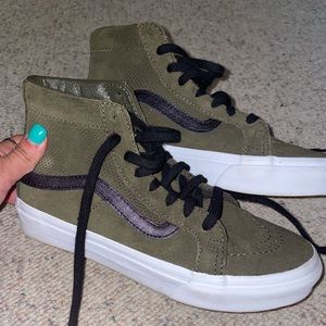 Woman’s dark green high top vans